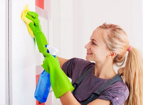 Cleaner dusting and vacuuming in a Hounslow family home